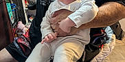 Spencer joined the competition — help win amazing prizes! adult, baby, chair, child, clothing, face, floor, hand, happy, holding, household_items, indoor, pajamas, person, shelf, shorts, sitting, smiling, tshirt, wood_floor