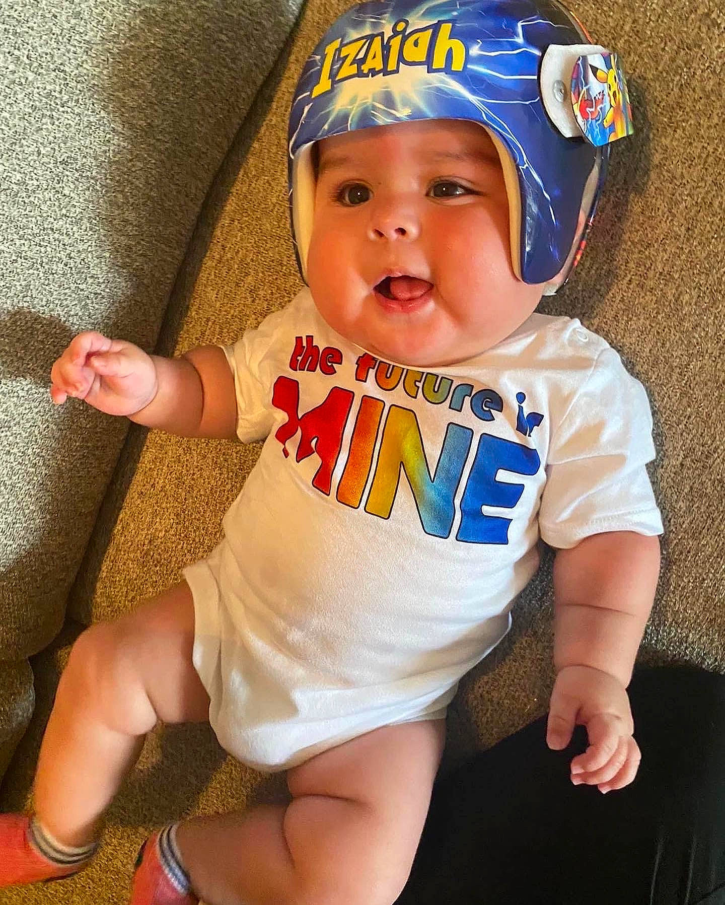 Izaiah is registered to the contest to win money with this photo: baby, baby_toddler_clothing, cap, cheek, child, face, finger, happy, headgear, headwear, human_leg, knee, leg, person, personal_protective_equipment, skin, sleeve, smile, t_shirt, thigh