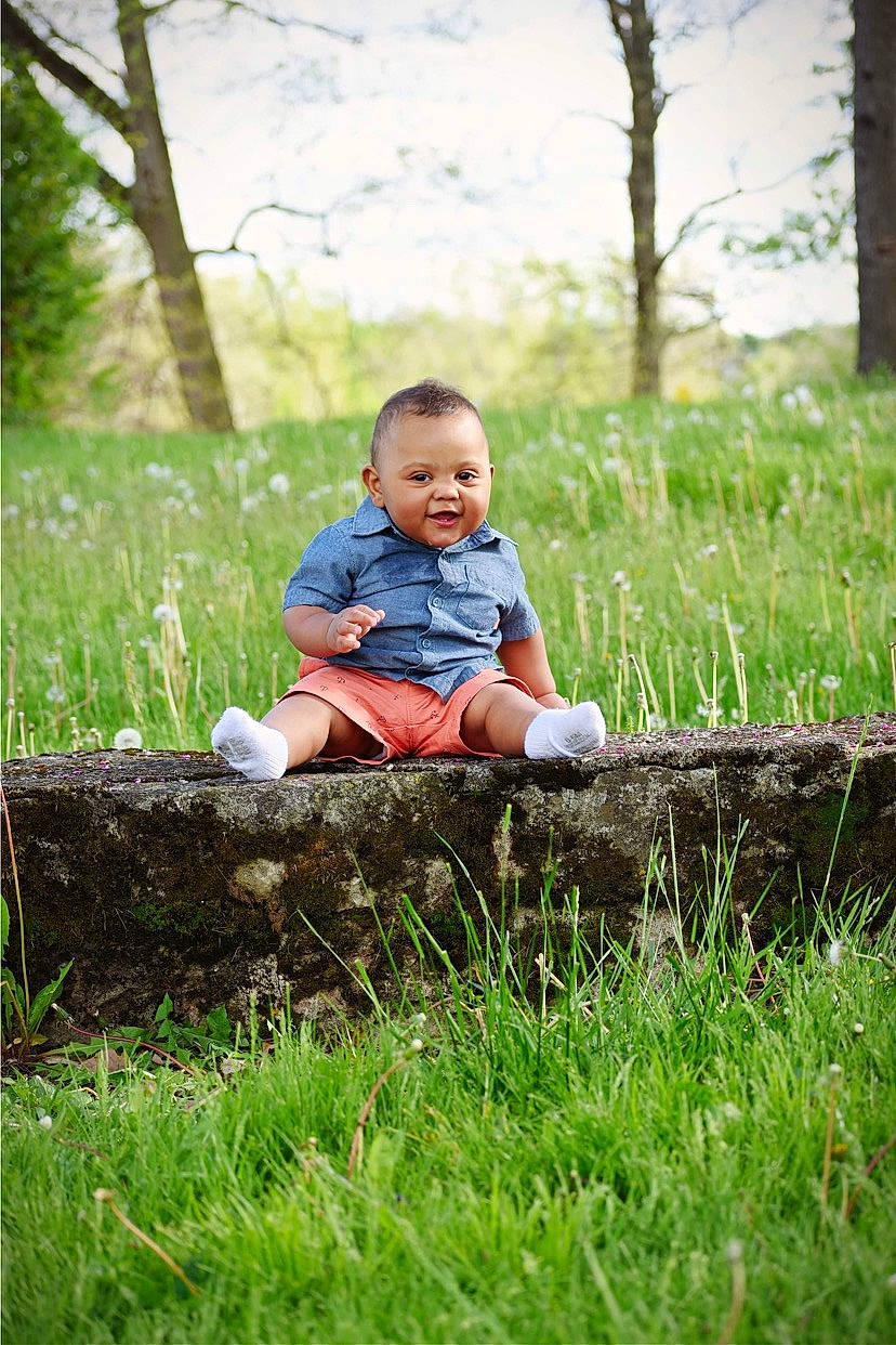 Amarion joined the competition — help win amazing prizes! baby, baby_toddler_clothing, child, grass, grassland, groundcover, happy, landscape, leisure, meadow, natural_landscape, people_in_nature, person, plant, prairie, sitting, sky, toddler, tree, wilderness