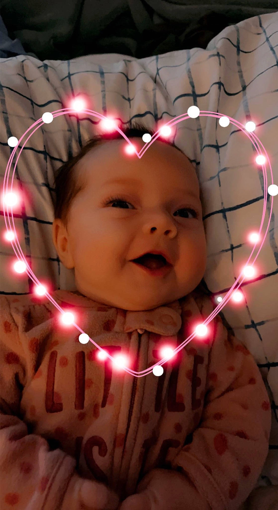 Everleigh is registered to the contest to win money with this photo: cheek, chin, christmas_ornament, eye, face, facial_expression, finger, hand, happy, head, headwear, human, human_body, light, lighting, lip, mouth, organ, person, photograph