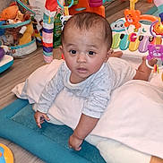 Mary Jane Yazzie joined the competition — help win amazing prizes! baby, infant, child, play_mat, toy, activity_arch, colorful, floor, indoor, curious, pillow, cushion, wooden_floor, smiling, cute, baby_clothes, playroom, early_learning, development, toddler