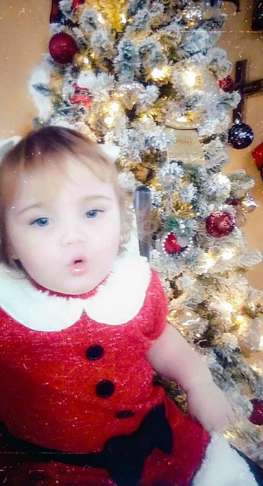 Mckenna is registered to the contest to win money with this photo: baby_toddler_clothing, christmas, christmas_decoration, christmas_ornament, christmas_tree, doll, dress, event, happy, holiday, holiday_ornament, lip, ornament, person, pink, plant, textile, toddler, tree, white