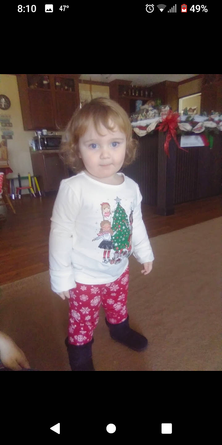 Mckenna is registered to the contest to win money with this photo: baby_toddler_clothing, cheek, child, facial_expression, floor, flooring, fun, hair, hardwood, head, iris, nose, pajamas, person, room, skin, sleeve, standing, t_shirt, toddler