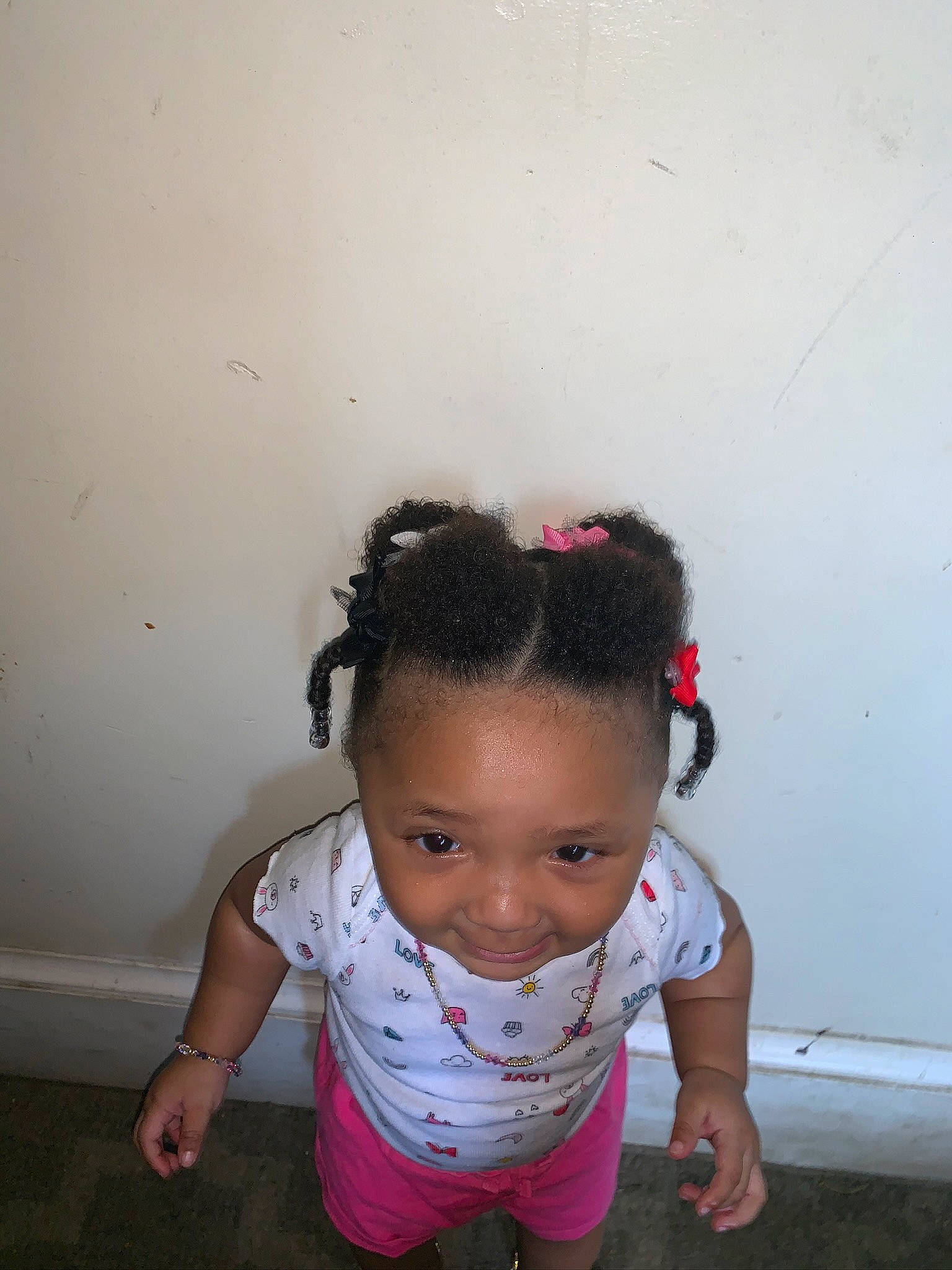 Kyrielle is registered to the contest to win money with this photo: baby, black_hair, cheek, child, ear, eye, face, forehead, fun, hair, hairstyle, head, joy, neck, person, pink, play, skin, smile, standing