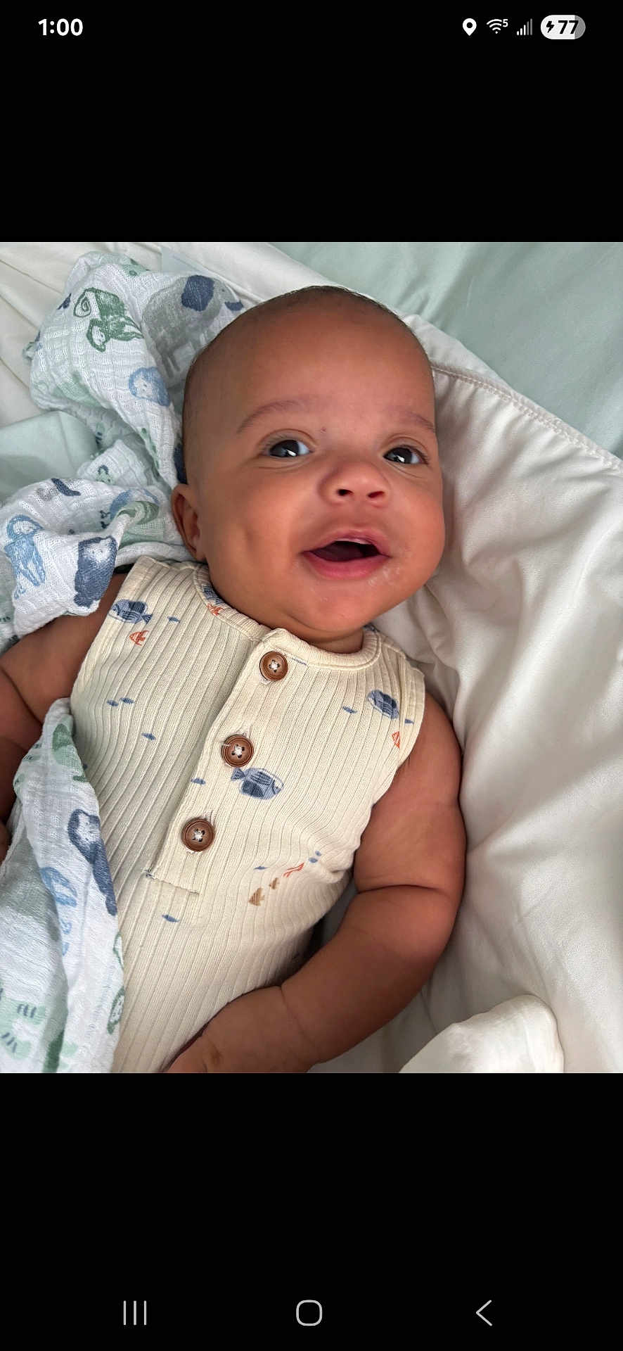 William joined the competition — help win amazing prizes! baby, infant, smiling, blanket, onesie, buttoned_clothing, bed, white_bed, lying_down, happy, cute, child, human, portrait, indoors, soft_texture, fabric, comfort, face, skin