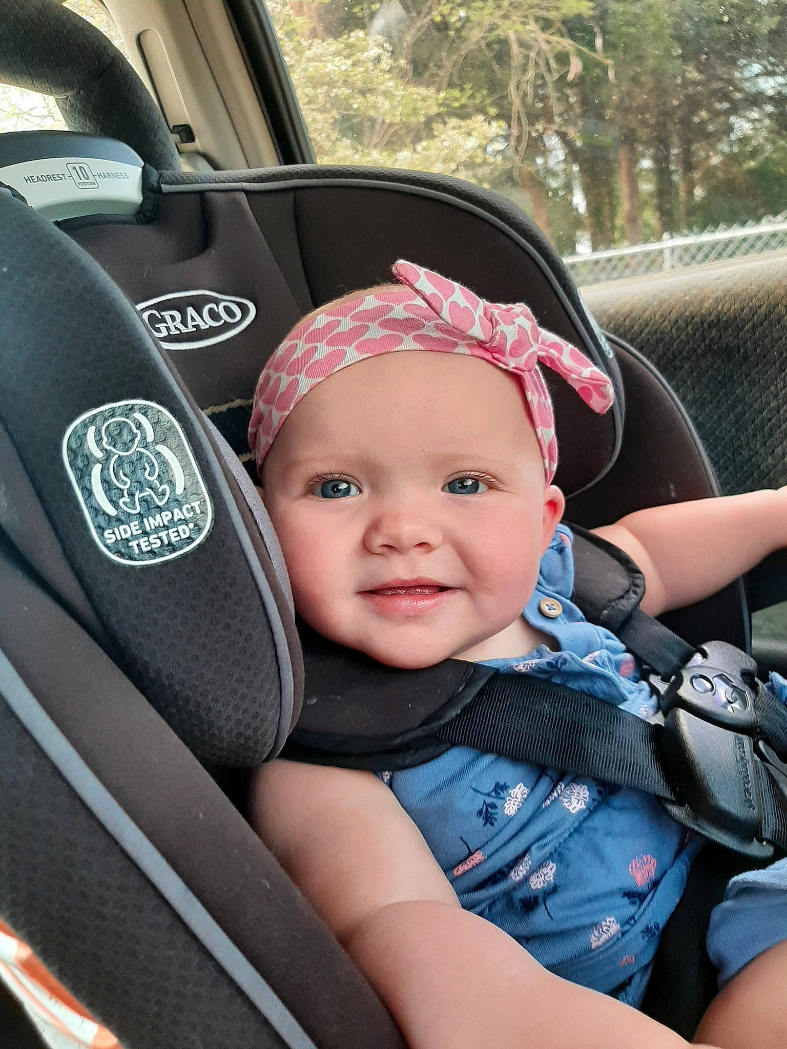 Evelyn Kent joined the competition — help win amazing prizes! auto_part, automotive_design, automotive_exterior, baby, baby_carriage, baby_toddler_clothing, car, car_seat, car_seat_cover, grass, headwear, motor_vehicle, person, plant, seat_belt, smile, steering_part, steering_wheel, toddler, tree