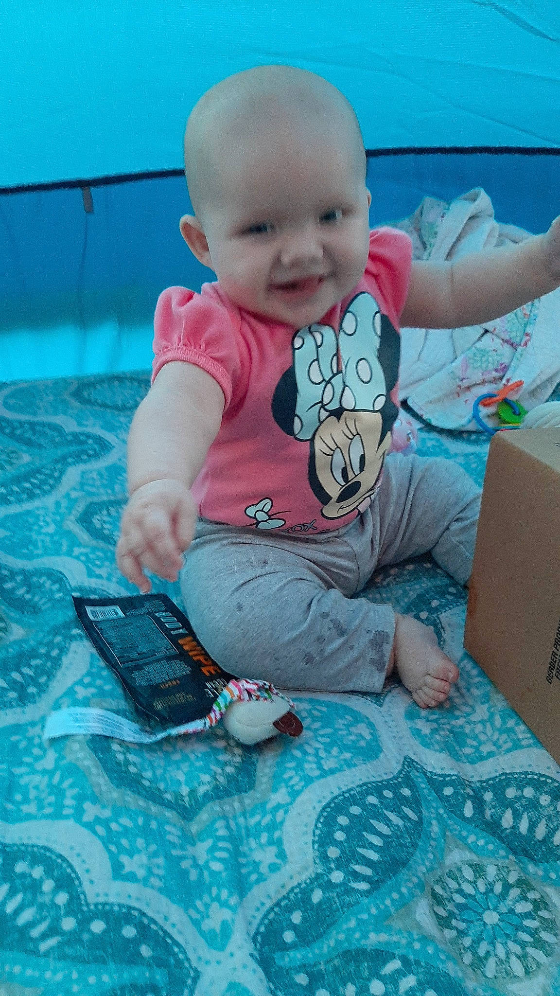 Evelyn joined the competition — help win amazing prizes! baby, baby_products, baby_toddler_clothing, blue, cheek, child, comfort, flooring, fun, happy, joy, leisure, person, pink, play, shipping_box, sitting, skin, smile, textile