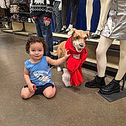 Liam joined the competition — help win amazing prizes! toddler, child, indoor, store, mannequin, clothing, decorative_dog, scarf, boots, floor, curly_hair, blue_shirt, toy, shopping, retail, casual, playful, smiling, person, portrait
