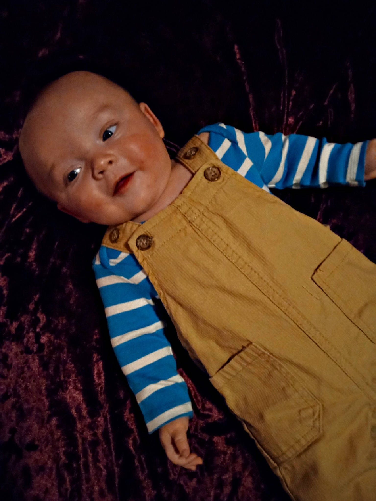 Greyson is registered to the contest to win money with this photo: baby, baby_products, baby_toddler_clothing, brown, cheek, child, comfort, flooring, fur, happy, linens, outerwear, pattern, person, room, sitting, sleeve, smile, textile, toddler