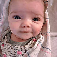 Ayla is registered to the contest to win money with this photo: baby, blanket, bonnet, clothing, face, happy, hat, head, hood, knitwear, newborn, person, photography, portrait, quilt, smile, spitting, sweater, towel