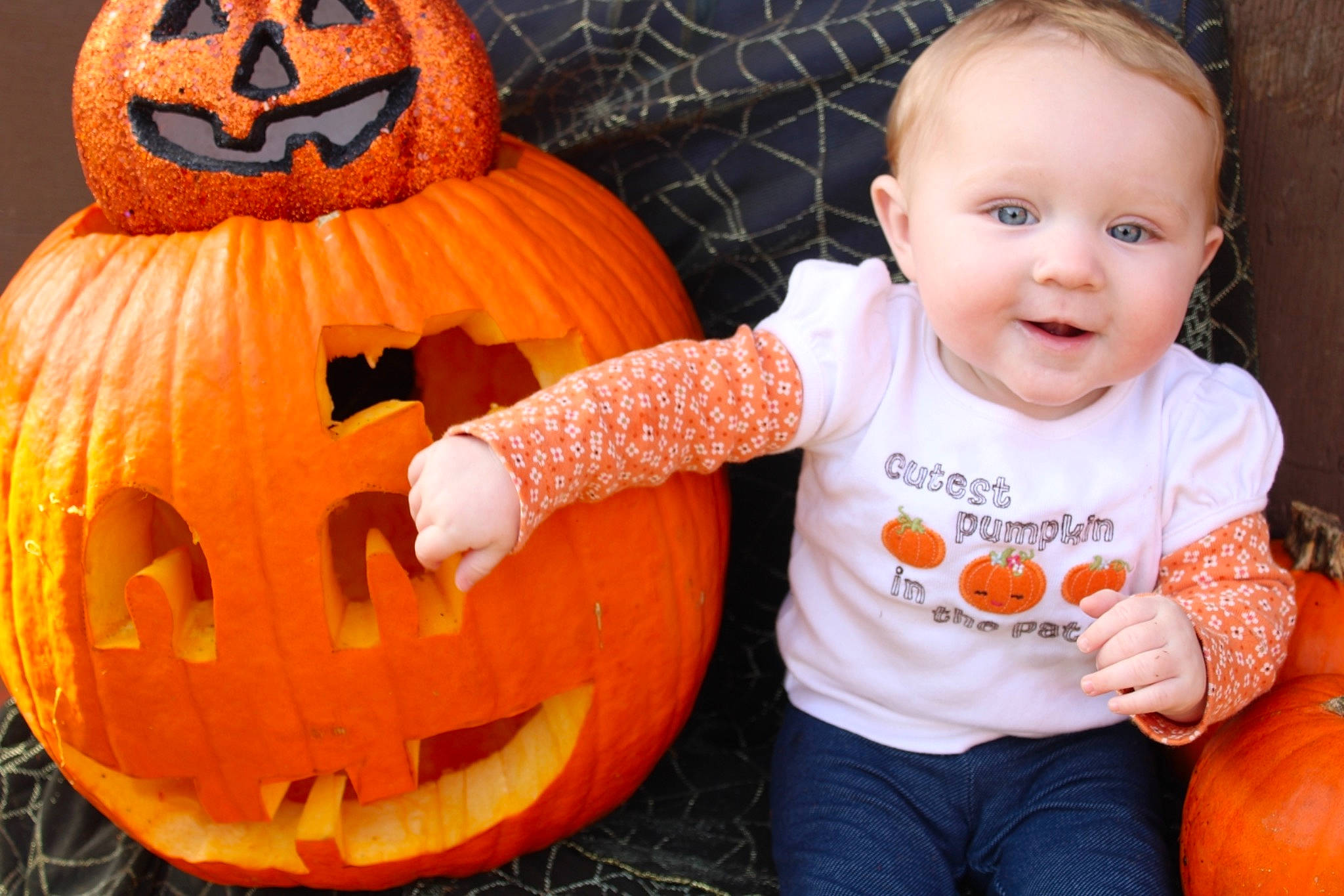 Chelsea is registered to the contest to win money with this photo: baby_toddler_clothing, black, calabaza, clothing, creative_arts, cucurbita, facial_expression, gourd, happy, head, mouth, natural_foods, orange, organ, person, photograph, plant, pumpkin, smile, squash