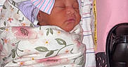 Demyah is registered to the contest to win money with this photo: baby, baby_carrier, blanket, bow, child, cozy, cute, floral, headwear, indoors, infant, newborn, person, pink, portrait, resting, sleeping, soft, striped, wrapped