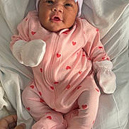 Demyah is registered to the contest to win money with this photo: adorable, baby, bow_hat, child, clothing, cute, hand, hearts_pattern, indoors, infant, lying_down, mittens, newborn, person, pink_onesie, portrait, sleepwear, soft_fabric, striped_hat, white_blanket