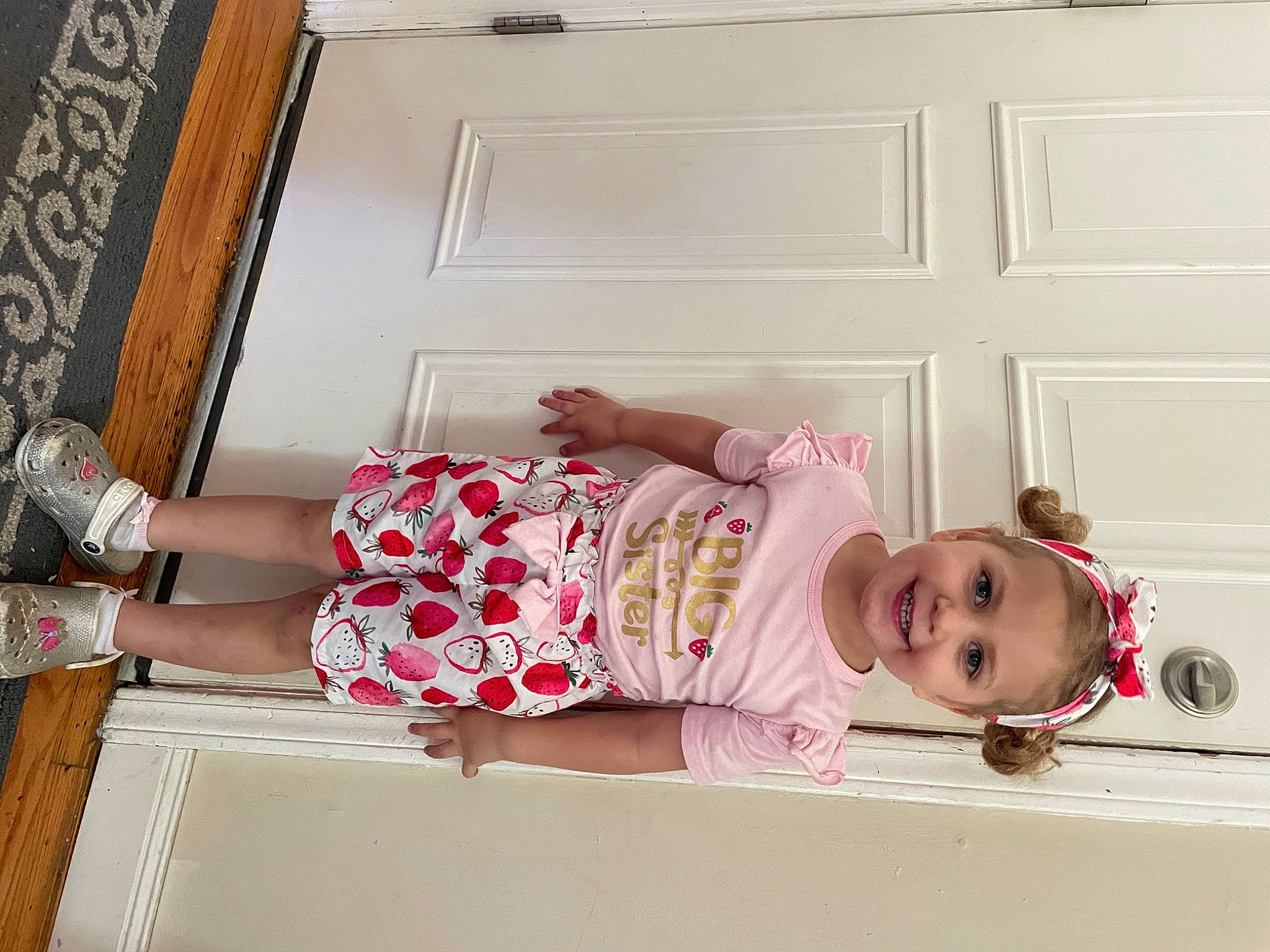 Maradelle is registered to the contest to win money with this photo: baby, baby_products, baby_toddler_clothing, child, door, happy, human_leg, joy, knee, linens, magenta, nightwear, pattern, peach, person, pink, room, sleeve, smile, thigh