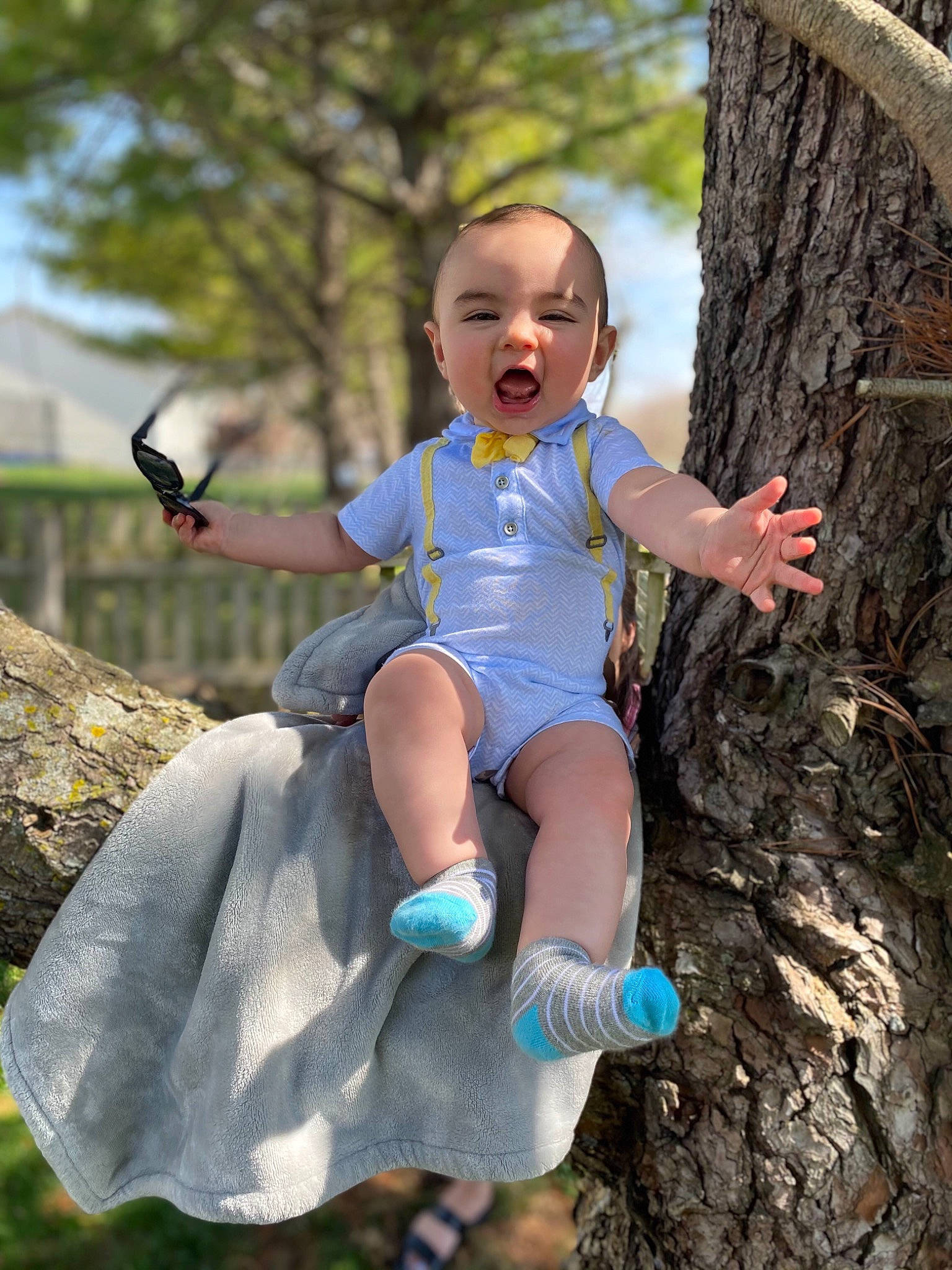 Drew is registered to the contest to win money with this photo: arm, azure, baby_toddler_clothing, branch, eye, facial_expression, finger, fun, grass, hand, happy, human, human_body, leaf, mammal, people_in_nature, person, standing, tree, vertebrate