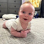 Lilith joined the competition — help win amazing prizes! baby, smiling, carpet, indoor, furniture, dresser, chair, child, happy, crawling, person, home, floor, cute, infant, plush, clothing, head, face, living_room