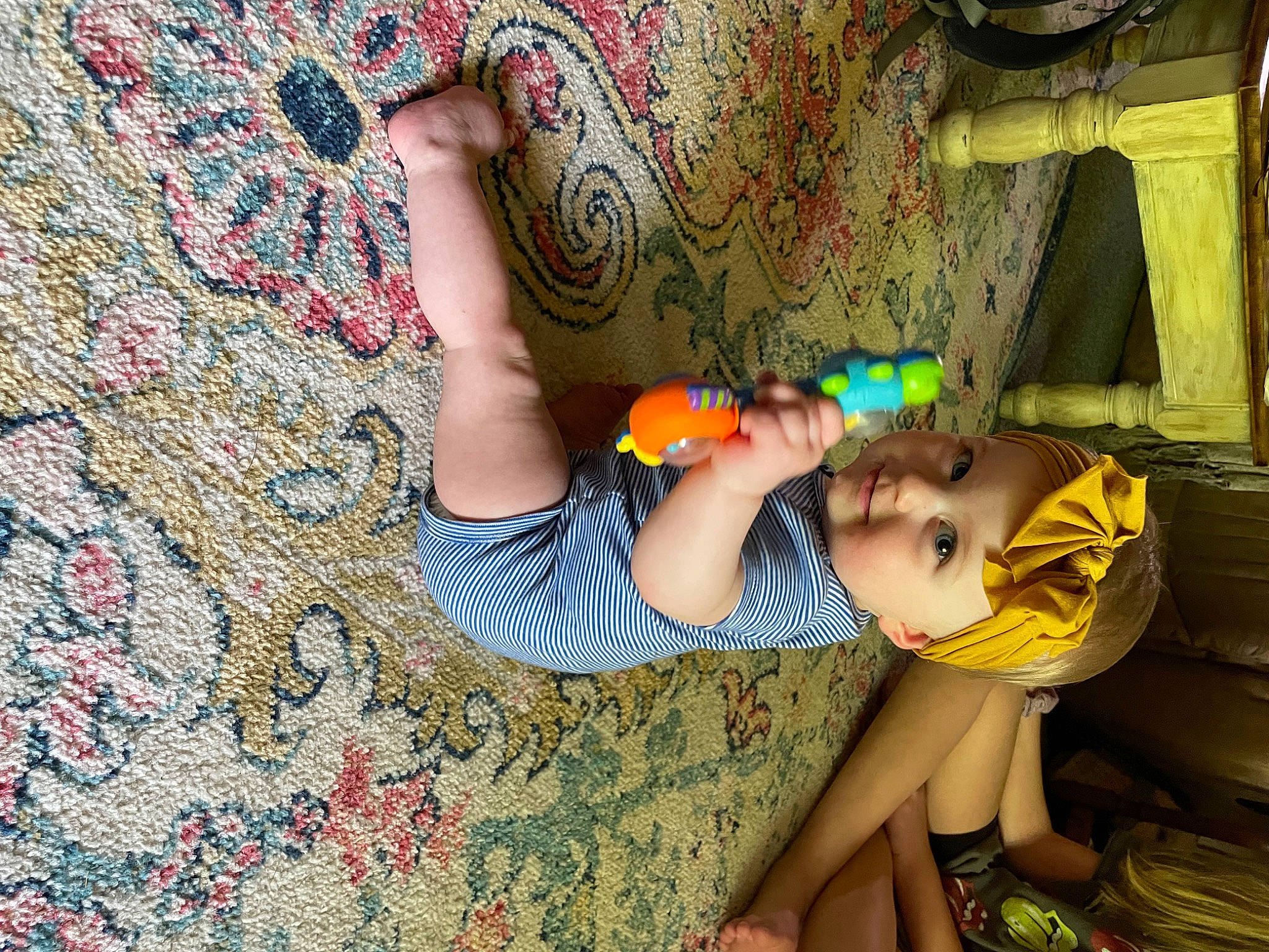 Kamryn is registered to the contest to win money with this photo: art, child, dress, flooring, foot, fun, hand, human_body, human_leg, leaf, leg, leisure, pattern, person, plant, sandal, textile, thigh, toddler, tree