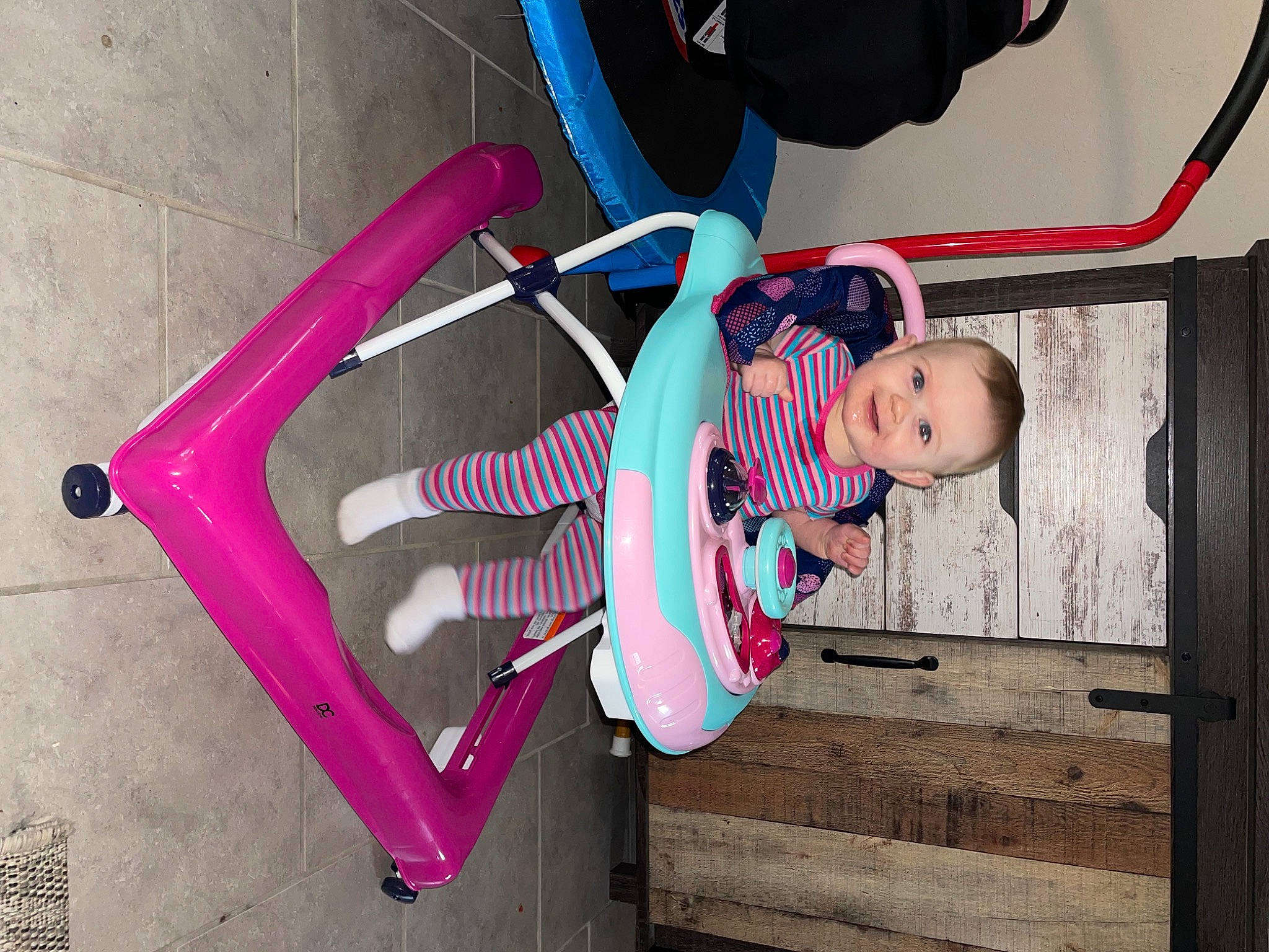 Kamryn is registered to the contest to win money with this photo: auto_part, baby, baby_carriage, baby_products, baby_toddler_clothing, child, door, electric_blue, fun, happy, joy, magenta, person, pink, purple, recreation, smile, stairs, tire, toddler