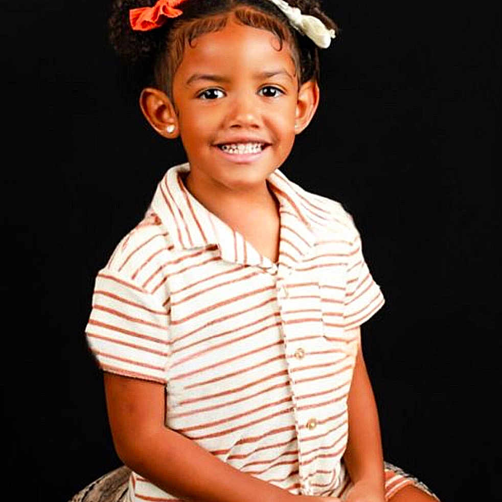 Aria joined the competition — help win amazing prizes! bodypart, child, clothing, dimples, dress, face, female, girl, hair, happy, head, mouth, person, photography, portrait, shorts, sitting, sleeve, smile, teeth
