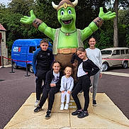 Lea a rejoint le concours — aidez-le/la à gagner de superbes lots ! car, casual_clothing, children, daytime, friends, fun, green, group, happy, outdoor, playful, posing, smiling, statue, trees, turtle, van, vehicle, viking, young