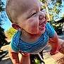 arms, baby, blue_shirt, cheerful, child, cute, daylight, face, happy, infant, nature, outdoor, palm_trees, person, playful, portrait, skin, smiling, sunlight, trees