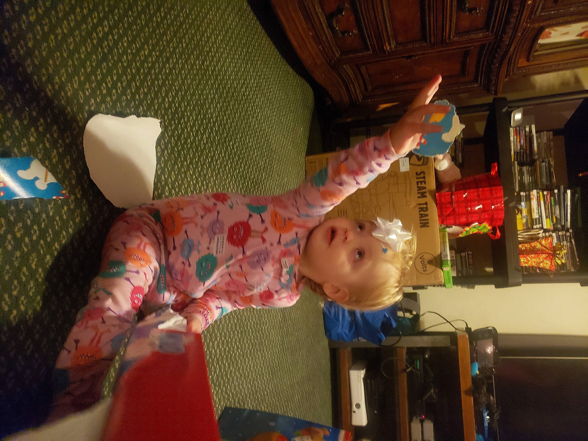 Adeline is registered to the contest to win money with this photo: baby, baby_products, baby_toys, ceiling, child, comfort, fun, leisure, living_room, person, play, room, sitting, sock, toddler, toy, tree