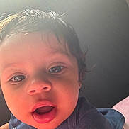 Macai joined the competition — help win amazing prizes! toddler, child, face, close_up, expression, curly_hair, sunlight, indoors, blue_shirt, mouth_open, cute, person, young_child, portrait, skin, eye, head, baby, human, soft_light