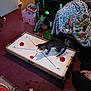 Mouse joined the competition — help win amazing prizes! air_hockey_table, animal, blanket, carpet, cat, colorful, cushion, dragon_figurine, electronics, furniture, game, human_hand, indoor, living_room, person, pet, playful, remote_control, television, toy
