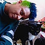 Bellatrix is registered to the contest to win money with this photo: person, cat, indoor, couch, black_and_white_cat, tuxedo_cat, short_hair, dyed_hair, green_hair, blue_hair, feline, pet, animal, casual_clothing, sofa, whiskers, closeup, face, looking_down, home