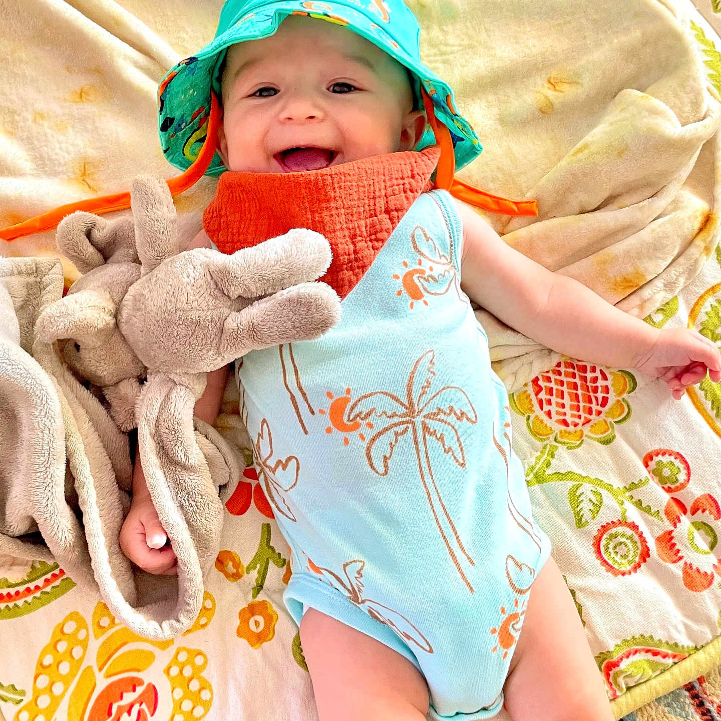 Killian joined the competition — help win amazing prizes! baby, babylaughing, blanket, bonnet, cap, clothing, dress, face, happy, hat, head, laughing, newborn, person, photography, portrait, quilt, sitting, smile, towel