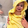 Penelope joined the competition — help win amazing prizes! baby, child, infant, smiling, bath_time, yellow_towel, hooded_towel, portrait, face, eyes, indoors, bathroom, bathtub, adult_hands, holding, wet_bath, towel, happy, cute, family