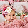 adorable, baby, bathtub, celebration, child, closeup, cute, decorative_flowers, festive, flower_headband, fluffy_clothing, girl, happy, indoor, infant, pearl_necklace, pink_dress, portrait, smiling, soft_lighting