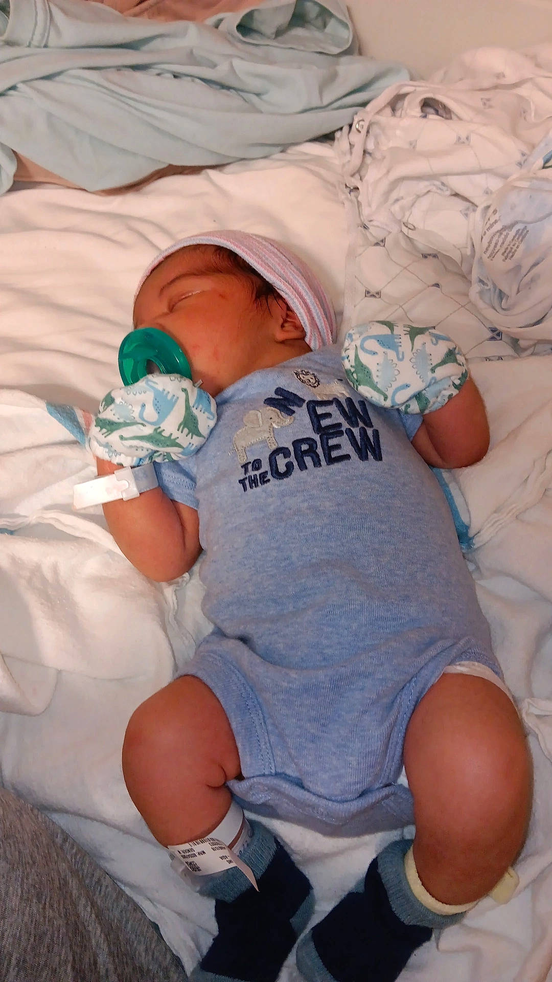 Karter is registered to the contest to win money with this photo: abdomen, baby, baby_products, baby_sleeping, baby_toddler_clothing, child, comfort, diaper, elbow, finger, foot, hat, human_leg, knee, linens, person, skin, t_shirt, thigh, toddler