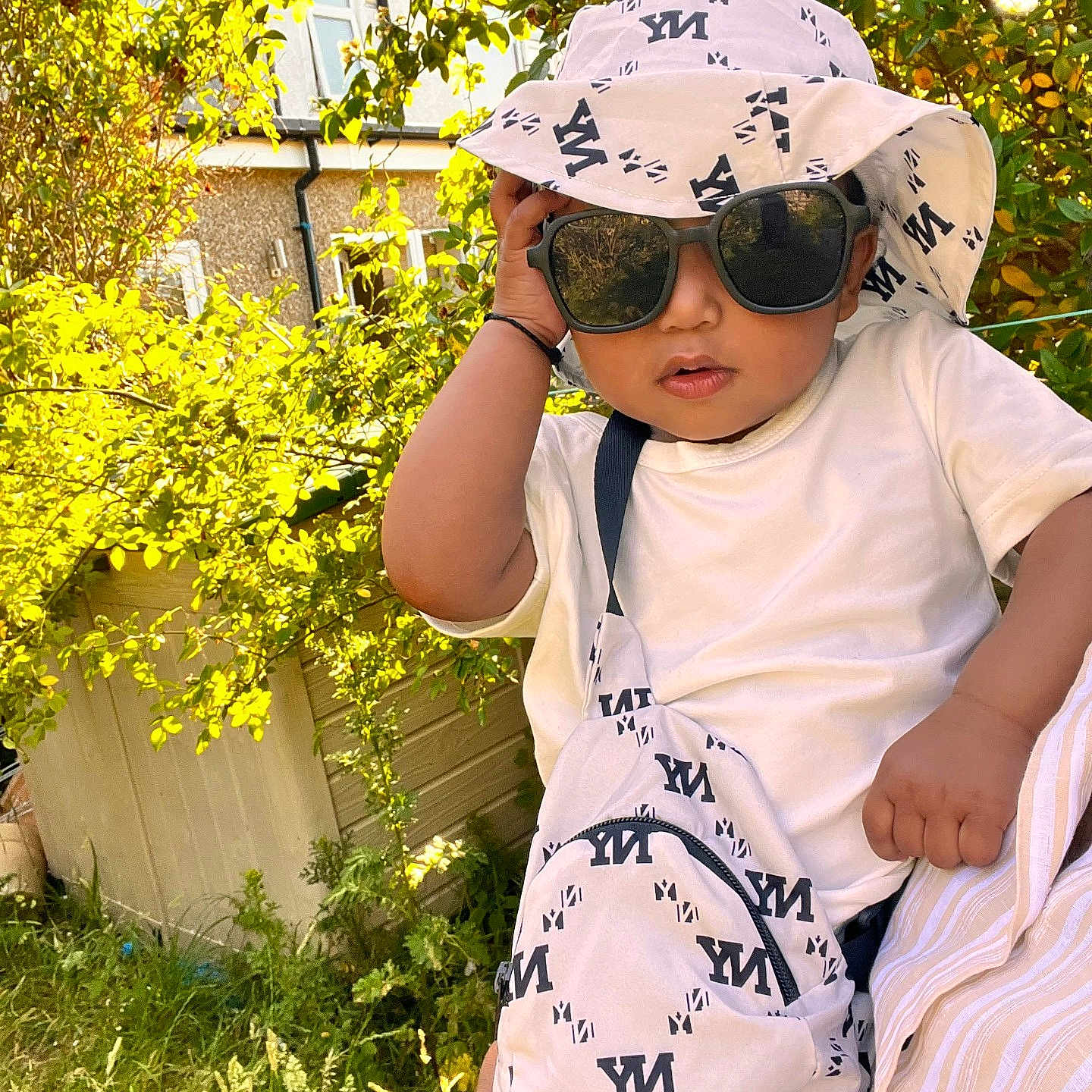 Arsalan joined the competition — help win amazing prizes! baby, bag, child, cute, fashion, garden, grass, greenery, hand, hat, house, ny_print, outdoor, person, portrait, summer, sunglasses, sunlight, toddler, white_clothing