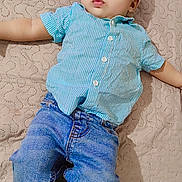 Azlaan is registered to the contest to win money with this photo: baby, child, infant, blue_shirt, denim_pants, barefoot, bed, quilt, patterned_bedspread, cute, lying_down, small_feet, curious_expression, indoor, casual_clothing, portrait, young_child, soft_lighting, relaxed, skin
