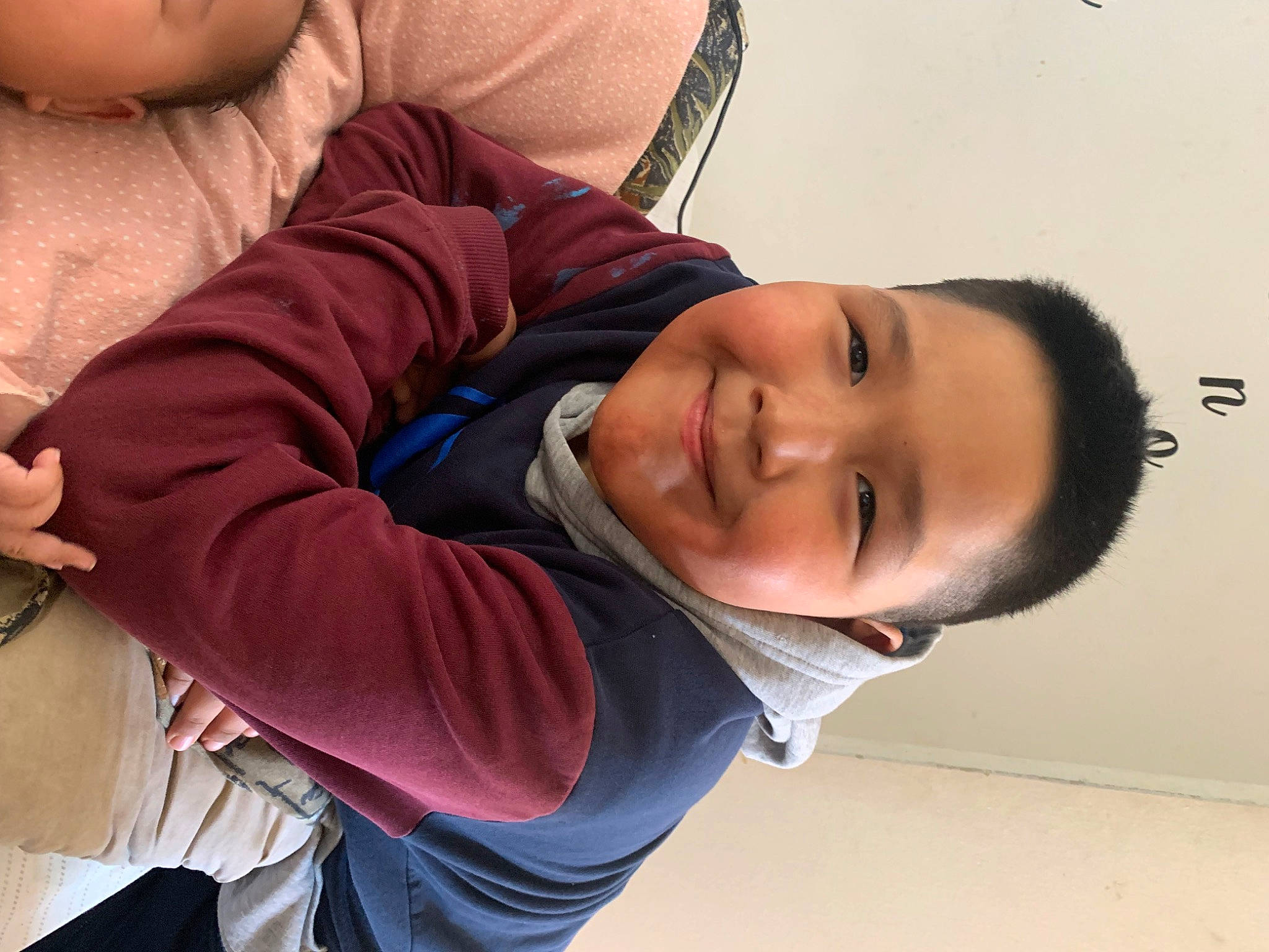 Denzel is registered to the contest to win money with this photo: beauty, cheek, child, comfort, elbow, eyelash, fun, happy, joint, joy, mouth, nose, organ, person, sitting, skin, sleeve, smile, toddler, tree