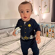 Jayden joined the competition — help win amazing prizes! baby, bed, bedding, bedroom, blanket, child, crib, cute, eyes, face, framed_art, hairbrush, holding_brush, indoor, lamp, pajamas, police_costume, socks, standing, toddler