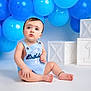 baby, child, birthday, blue_balloons, romper, first_birthday, sitting, cute, portrait, studio, white_floor, decorations, infant, celebration, happy, one_year_old, smile, soft_lighting, innocent, curious