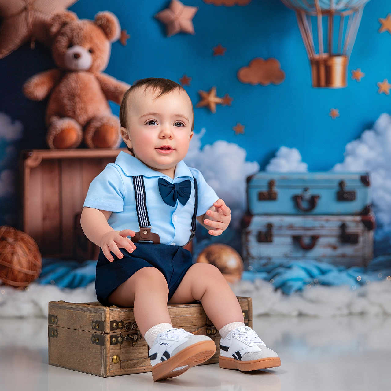 Jayden is registered to the contest to win money with this photo: baby, blue_shirt, bow_tie, child, clouds, cute, decor, floor_reflection, hot_air_balloon, indoor, portrait, sitting, stars, studio, suitcase, suspenders, teddy_bear, toddler, white_shoes, wooden_chest