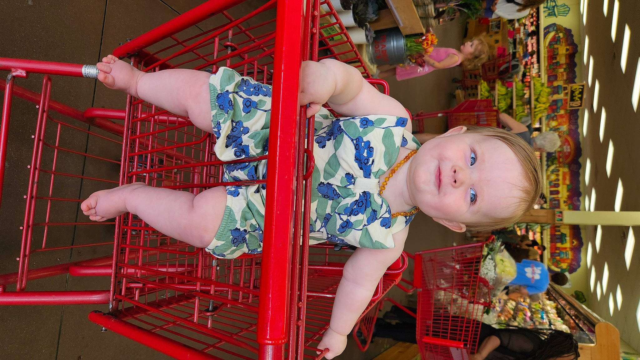 Juliette is registered to the contest to win money with this photo: amusement_ride, baby_products, child, doll, event, fun, human_leg, leisure, magenta, pattern, person, pink, retail, room, sandal, shelf, smile, textile, thigh, toddler