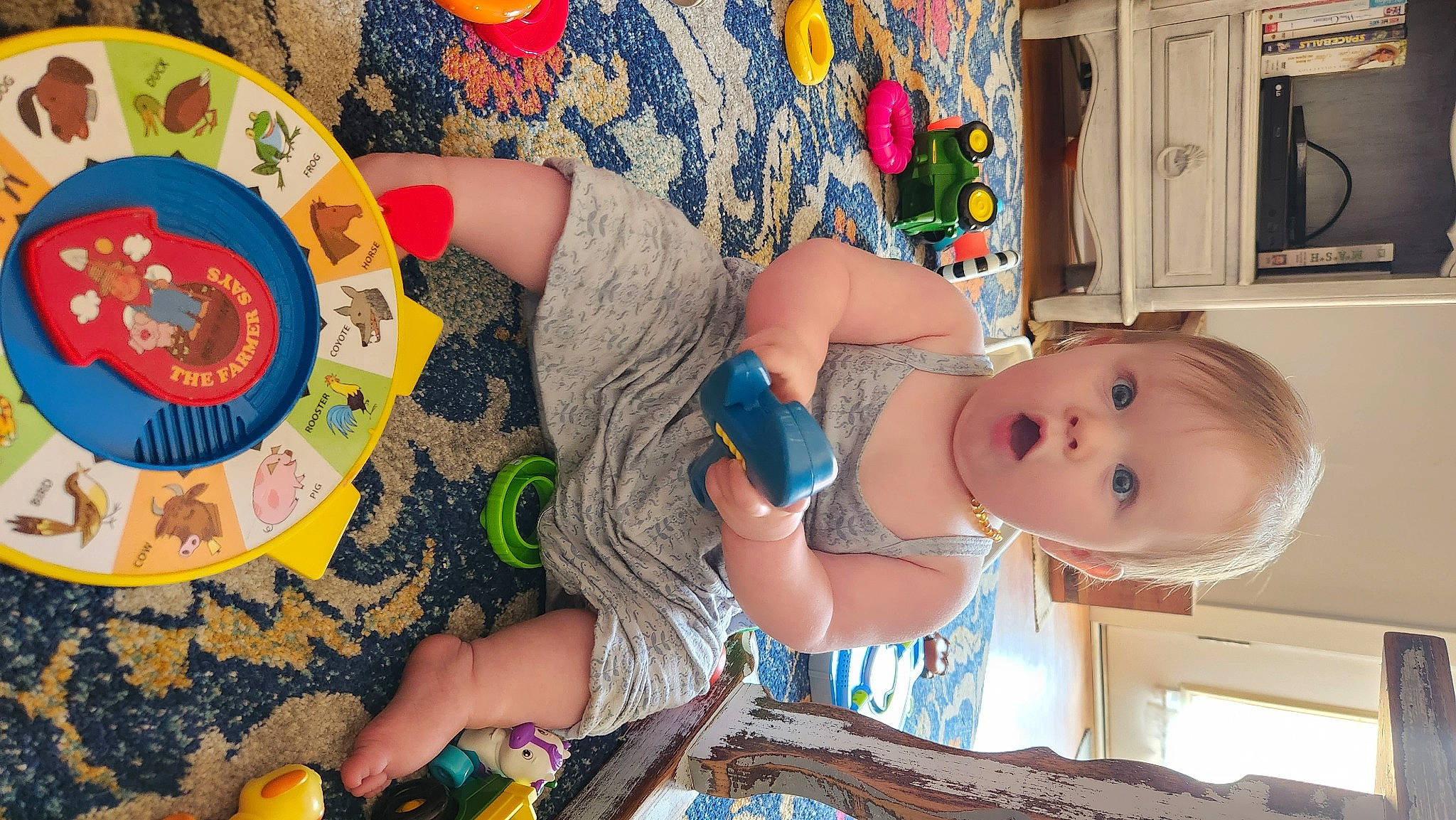 Juliette is registered to the contest to win money with this photo: art, baby, baby_toddler_clothing, child, fun, happy, human, leisure, people, person, play, product, room, summer, surprise, t_shirt, textile, toddler, toy, vacation