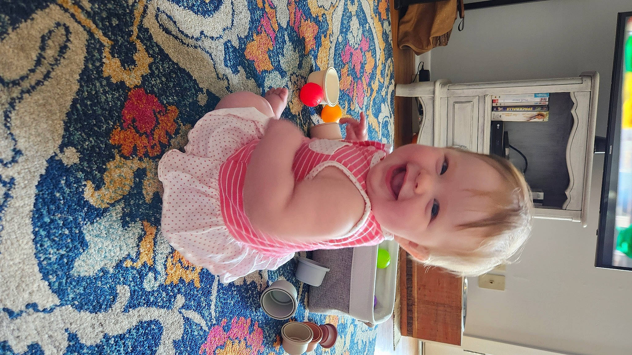 Juliette is registered to the contest to win money with this photo: baby, baby_products, baby_toddler_clothing, cheek, child, eye, fun, happy, human_leg, joy, pattern, person, room, skin, smile, toddler