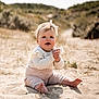 baby, child, sand, beach, sitting, headband, clapping, smiling, sunlight, nature, outdoor, dunes, grass, cute, infant, happy, portrait, clothing, feet, hands