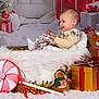 baby, basket, child, christmas, cozy, cute, decorations, festive, fluffy, gift_box, gingerbread, holiday, indoor, peppermint_candy, portrait, present, smiling, snow, stuffed_toy, teddy_bear