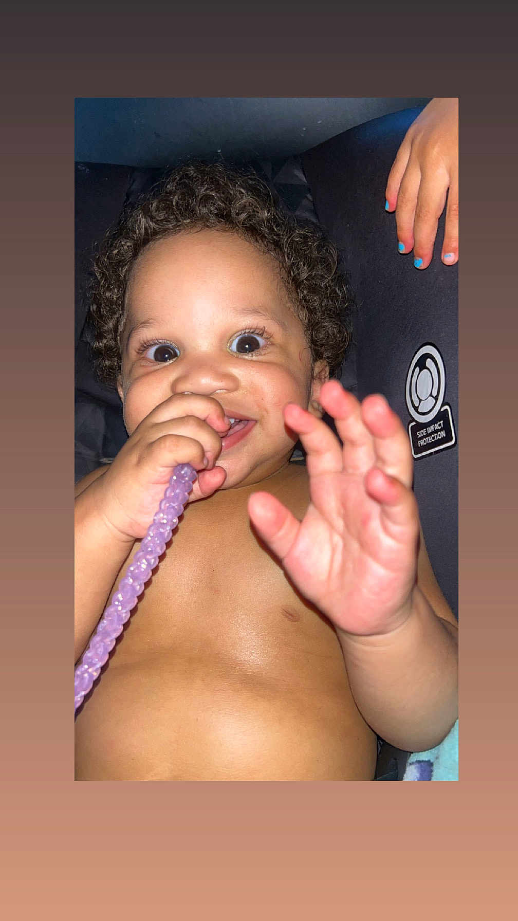 Amir joined the competition — help win amazing prizes! toddler, child, curly_hair, smiling, happy, hand, car_seat, purple_beads, nail_polish, skin, face, mouth, eyes, baby, close_up, indoors, person, protection_label, cute, playful