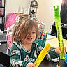Madalyn joined the competition — help win amazing prizes! toddler, child, happy, smiling, toy, bubble_wand, indoor, living_room, clothing, table, snack, candy, furniture, hair, person, play, fun, face, expression, home