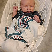 Zachary is registered to the contest to win money with this photo: baby, blanket, baby_seat, zigzag_pattern, curious, infant, cushion, indoor, child, comfortable, striped_blanket, fist, young_child, face, portrait, resting, soft_fabric, home, newborn, clothing