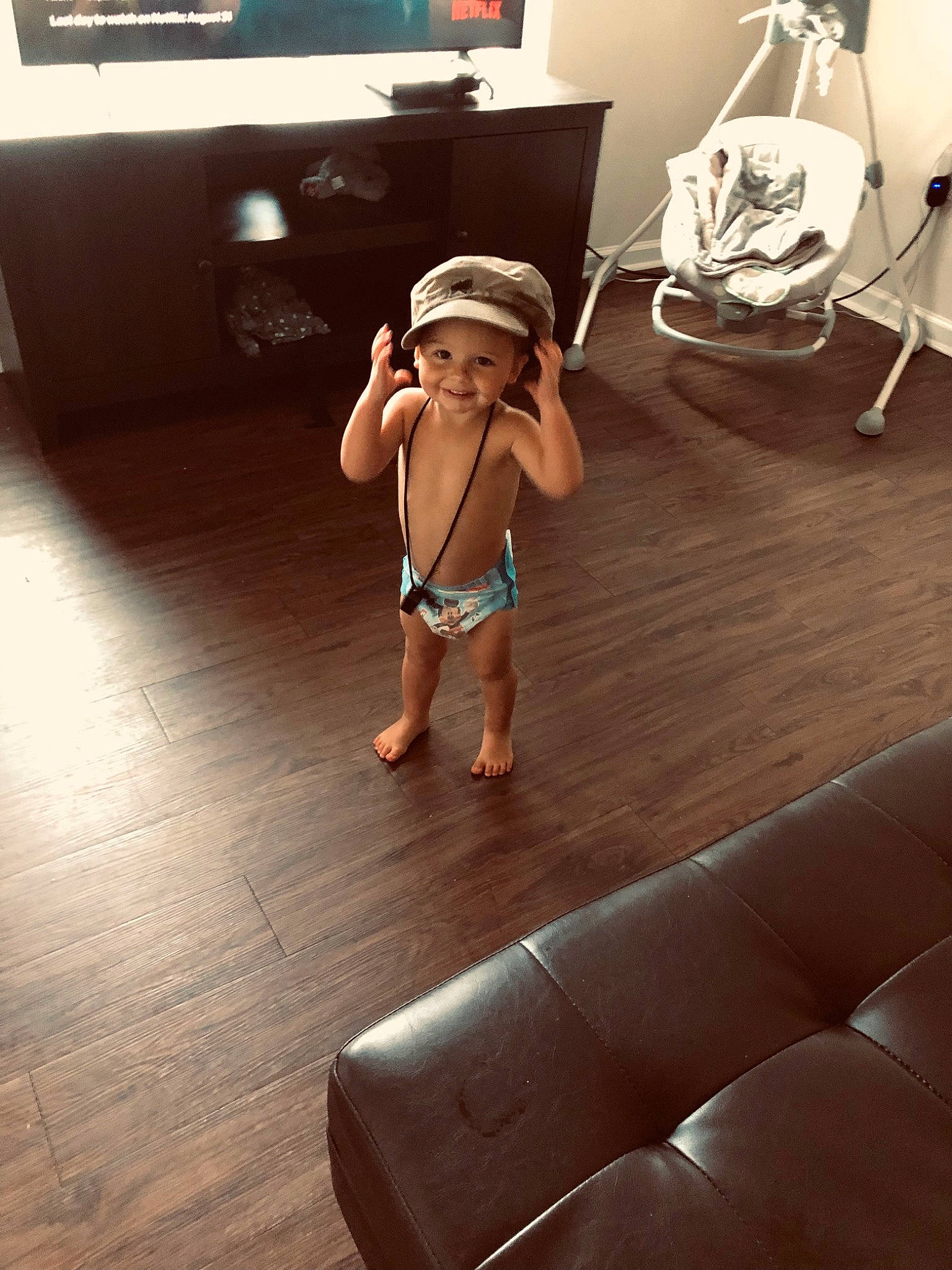 Chase is registered to the contest to win money with this photo: barefoot, comfort, floor, flooring, foot, hardwood, headwear, home_appliance, human_body, human_leg, joy, knee, laminate_flooring, leisure, living_room, person, room, selfie, television, thigh