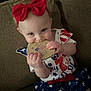 Eleanor is registered to the contest to win money with this photo: accessories, baby, bodypart, clothing, costume, couch, cushion, dress, face, finger, food, formalwear, furniture, hand, head, homedecor, person, photography, portrait, sweets