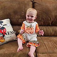 Eleanor is registered to the contest to win money with this photo: architecture, baby, building, clothing, couch, cushion, face, furniture, happy, head, homedecor, indoors, livingroom, person, photography, pillow, portrait, room, shorts, sitting